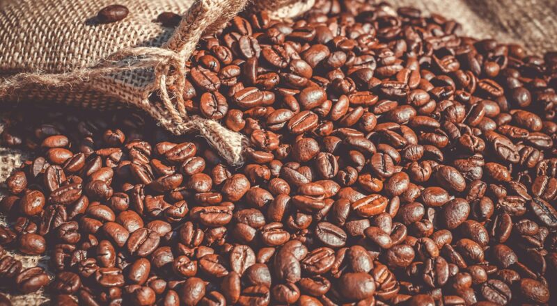brown coffee beans on brown sand
